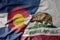 big waving colorful national flag of california state and flag of colorado state