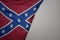 big waving national colorful confederate jack flag on the gray background