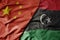 big waving national colorful flag of china and national flag of libya