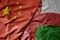 big waving national colorful flag of china and national flag of oman