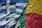 big waving national colorful flag of greece and national flag of benin