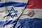 big waving national colorful flag of israel and national flag of paraguay