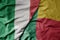 big waving national colorful flag of italy and national flag of benin