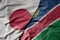 big waving national colorful flag of japan and national flag of namibia