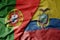 big waving national colorful flag of portugal and national flag of ecuador