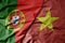 big waving national colorful flag of portugal and national flag of vietnam