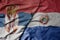 big waving national colorful flag of serbia and national flag of paraguay