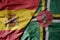 big waving national colorful flag of spain and national flag of dominica