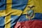 big waving national colorful flag of sweden and national flag of ecuador