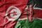 big waving national colorful flag of tunisia and national flag of kenya