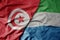 big waving national colorful flag of tunisia and national flag of sierra leone