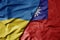 big waving national colorful flag of ukraine and national flag of taiwan