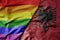 big waving realistic national colorful flag of albania and rainbow gay pride flag