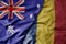 big waving realistic national colorful flag of australia and national flag of romania