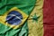 big waving realistic national colorful flag of brazil and national flag of senegal