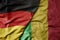 big waving realistic national colorful flag of germany and national flag of mali