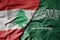 big waving realistic national colorful flag of lebanon and national flag of saudi arabia