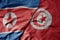 big waving realistic national colorful flag of north korea and national flag of tunisia