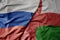 big waving realistic national colorful flag of russia and national flag of oman