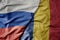 big waving realistic national colorful flag of russia and national flag of romania