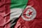 big waving realistic national colorful flag of united arab emirates and national flag of tunisia