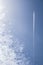 Big white airplane with four engines over blue cloudy sky