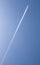 Big white airplane with four engines over blue cloudy sky