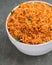 A big white bowl filled with tasty Nigerian Jollof Rice