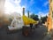 Big white cement buddha statue wearing a yellow coat and pagoda with sunlight at Wat Yai Chaimongkol Chaimongkhon.