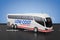 Big White Coach Tour Inter City Travel Bus with Low Cost Sign. 3d Rendering