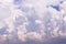 Big white cumulus clouds against blue sky background, epic cloud abstract texture in sunlight, thunderstorm