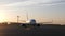 Big white plane preparing to fly starting to move on runway at sunset.