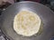 A big white puri on the frying pan