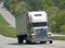 Big White Truck Climbing Hill On Interstate