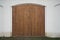 Big wooden barn gate. Monumental farm door, two timber leaf, closed brown gateway with planks and nails