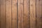 Big wooden barn gate. Monumental farm door, two timber leaf, closed brown gateway with planks and nails