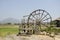 Big wooden turbine baler water wheel at Thai Dam Cultural Village in Chiang Khan at Loei, Thailand