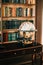 Big wooden vintage globe in a table near bookshelf in library