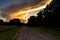 Big Yellow Cloud at Dusk Dirt Road Disappearing Into Disatance