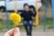 Big yellow dandelion close-up on the background of swinging on the swing boy