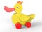 Big yellow duck toy on wheels. 3D image isolated on white