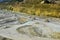 Big yellow mining trucks working in the limestone open-pit. Loading and transportation of minerals in the chalk open-pit.