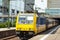 Big yellow powerful diesel locomotive for a passenger train
