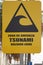 Big yellow tsunami warning sign on the street of Iquique Chile