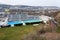 Biggest swimming complex with indoor and outdoor pools, toboggan water slide and diving towers with Vltava river in background