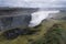 Biggest waterfall in Europe, Dettifoss. Muddy waters falling over the edge. Majestic Icelandic waterfall on a rainy day