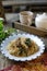 Bihun Goreng or fried vermicelli with vegetables on white plate.