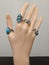 Bijou silver rings with blue stones on mannequin hand