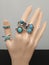 Bijou silver rings with blue stones on mannequin hand