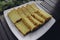 Bika Ambon, Indonesian cake with square slices in white plate. Yellow cake from Medan, Indonesia